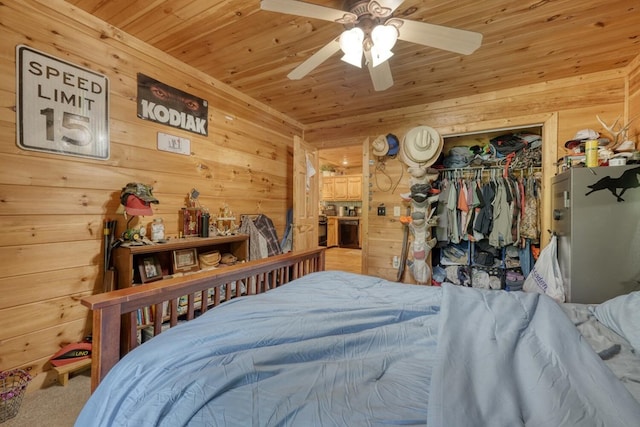 bedroom featuring ceiling fan, carpet floors, a closet, and wood ceiling