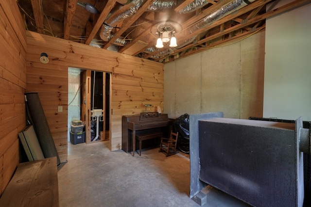 miscellaneous room with wood walls and concrete flooring