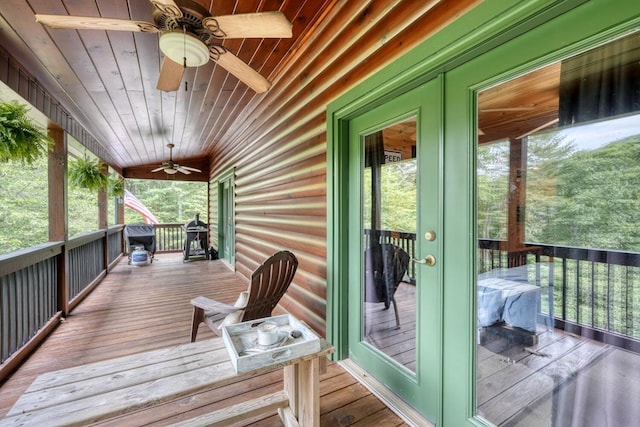 wooden deck featuring covered porch and french doors