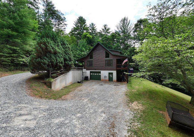 view of side of home featuring a deck and a garage