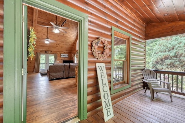 wooden terrace with ceiling fan and covered porch