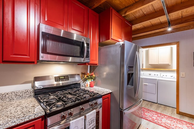 kitchen featuring wooden ceiling, light wood-style flooring, appliances with stainless steel finishes, independent washer and dryer, and beam ceiling