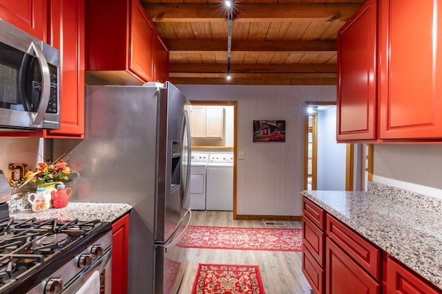 kitchen featuring wooden ceiling, washing machine and dryer, stainless steel appliances, light wood-type flooring, and beamed ceiling