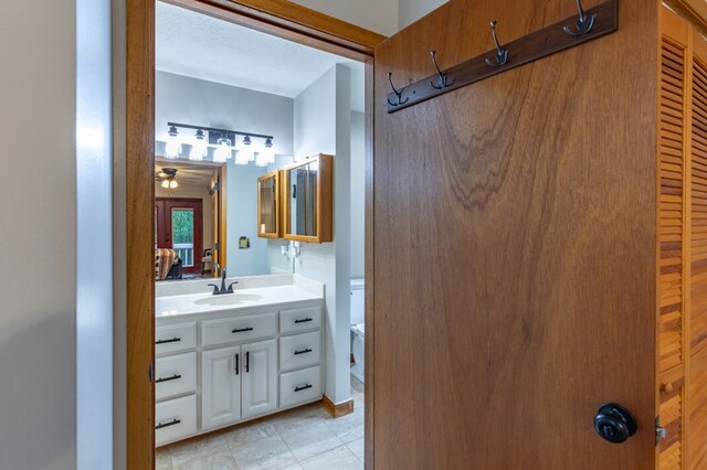 bathroom featuring a shower stall, vanity, and a textured ceiling