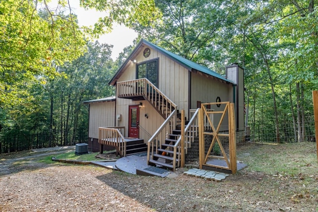 view of outbuilding featuring stairs and central AC