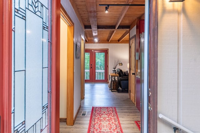 hall with french doors, track lighting, light wood-type flooring, wooden ceiling, and beamed ceiling