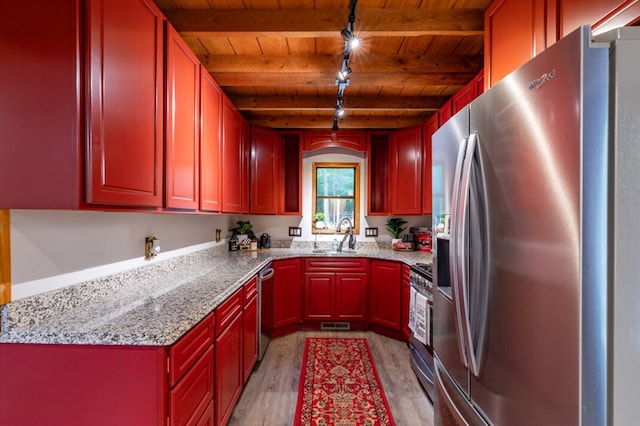 kitchen with reddish brown cabinets, beam ceiling, stainless steel appliances, light wood-type flooring, and wooden ceiling