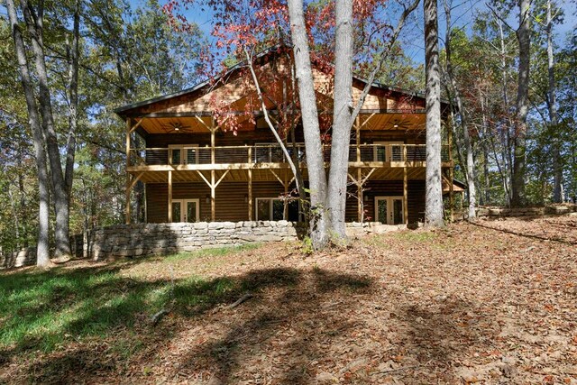 rear view of property with french doors and a deck