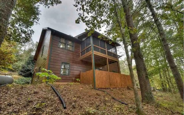 back of property with a sunroom