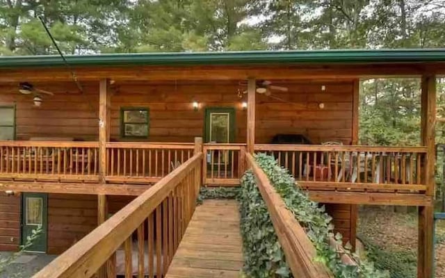 wooden deck featuring ceiling fan