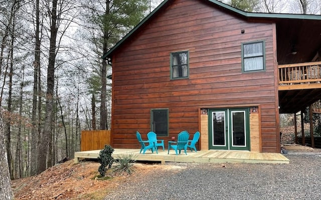 rear view of house with a deck and a patio area