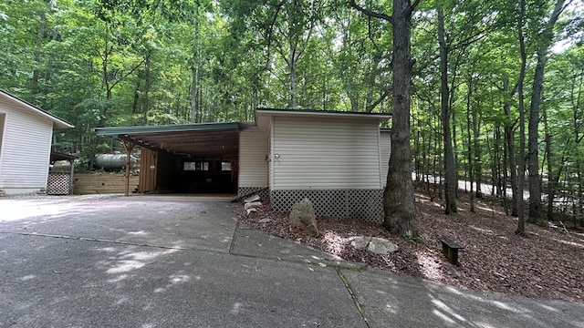 143 Sorghum Mill Run, Blairsville, GA 30512 - garage with driveway, a carport, and a forest view