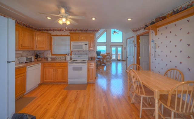 kitchen featuring white appliances, ceiling fan, and light wood-type flooring