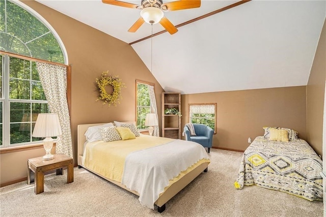 bedroom with a ceiling fan, vaulted ceiling, carpet, and baseboards