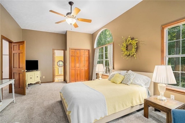 bedroom featuring a closet, carpet floors, ceiling fan, and vaulted ceiling