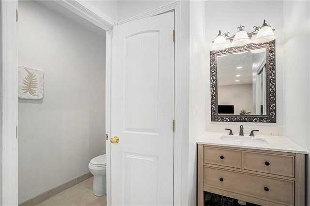 bathroom featuring tile patterned floors, baseboards, toilet, and vanity