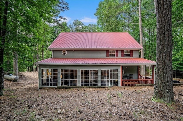 view of front facade featuring metal roof and a sunroom