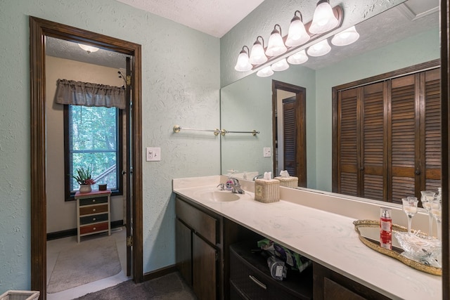 bathroom with a textured ceiling and vanity