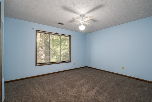 carpeted spare room featuring a textured ceiling and ceiling fan