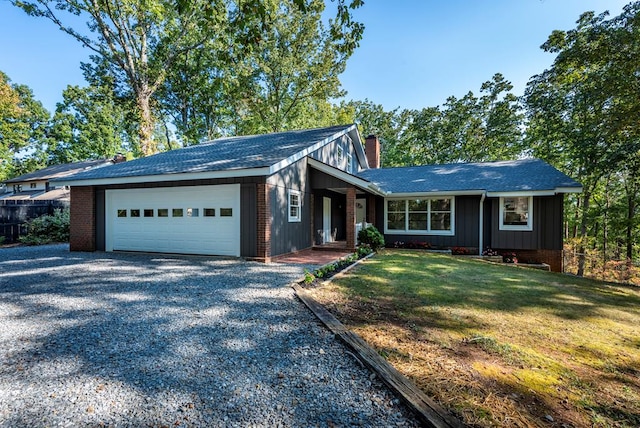 ranch-style house featuring a front lawn and a garage