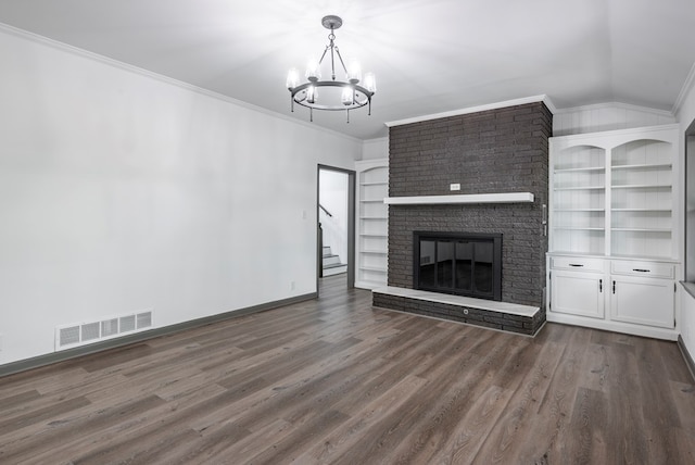 unfurnished living room with lofted ceiling, an inviting chandelier, crown molding, a brick fireplace, and dark hardwood / wood-style floors