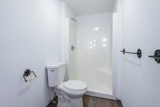 bathroom with wood-type flooring, toilet, and walk in shower