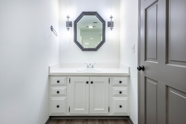 bathroom with hardwood / wood-style floors and vanity