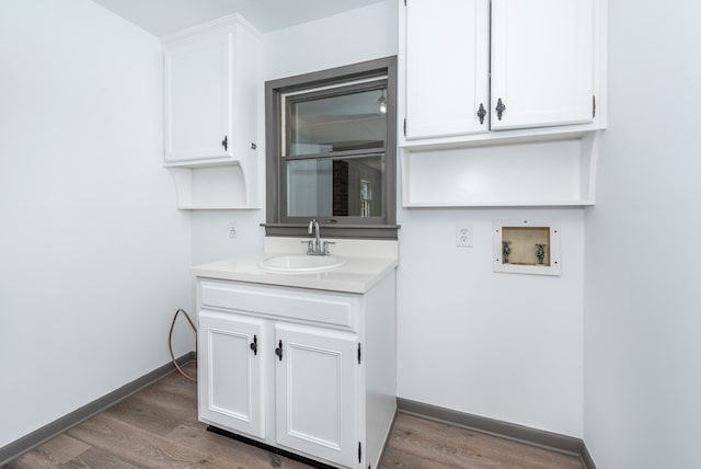 bathroom with hardwood / wood-style floors and vanity