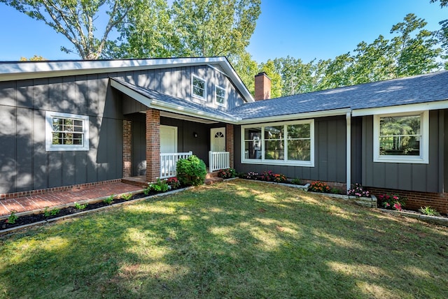 single story home with a porch and a front yard