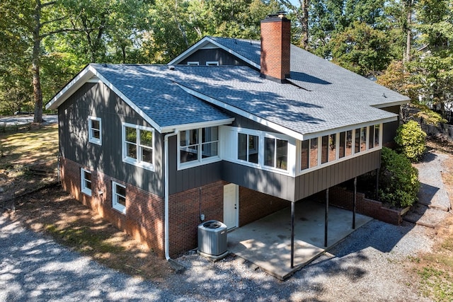 back of house featuring a patio area, a sunroom, and central AC unit