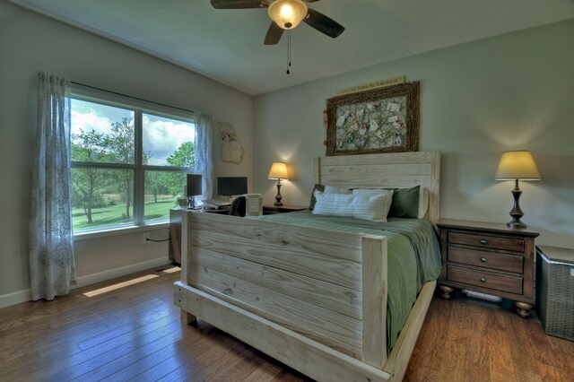 bedroom featuring a ceiling fan, baseboards, and wood finished floors
