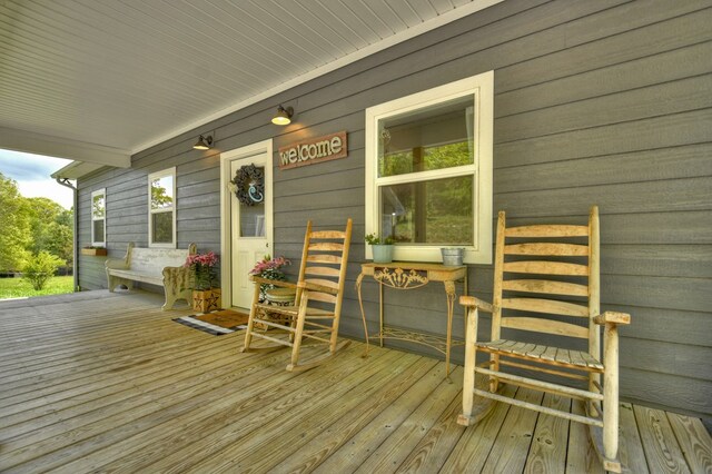 wooden terrace featuring covered porch