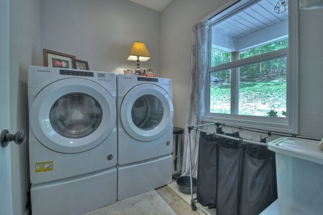 washroom with independent washer and dryer and laundry area