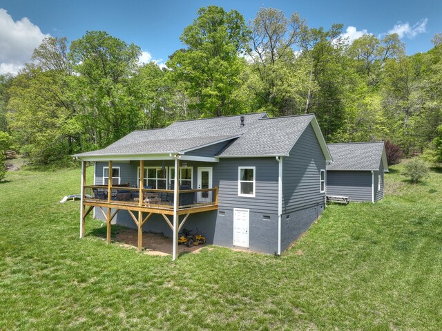 back of house featuring roof with shingles, a wooden deck, a lawn, and crawl space