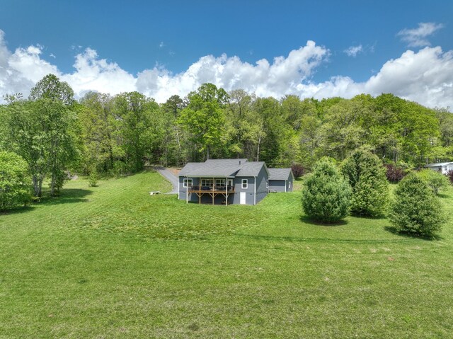 birds eye view of property with a view of trees