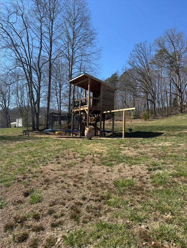 view of yard with a deck and a trampoline