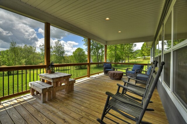 wooden terrace featuring a yard