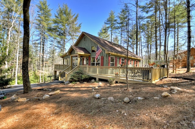 rustic home featuring board and batten siding and a deck