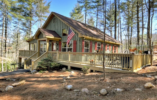 chalet / cabin with board and batten siding and a wooden deck