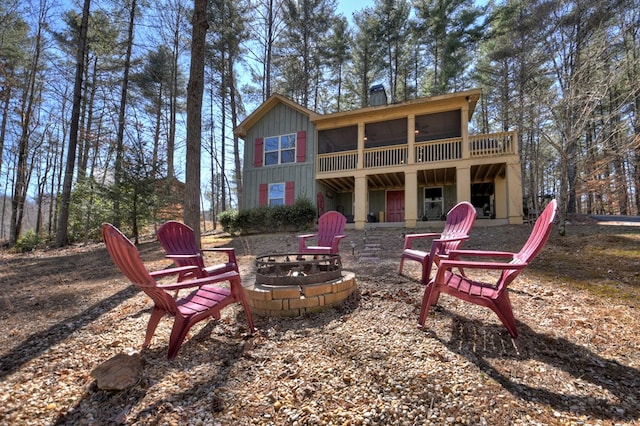 rear view of house featuring an outdoor fire pit and a deck