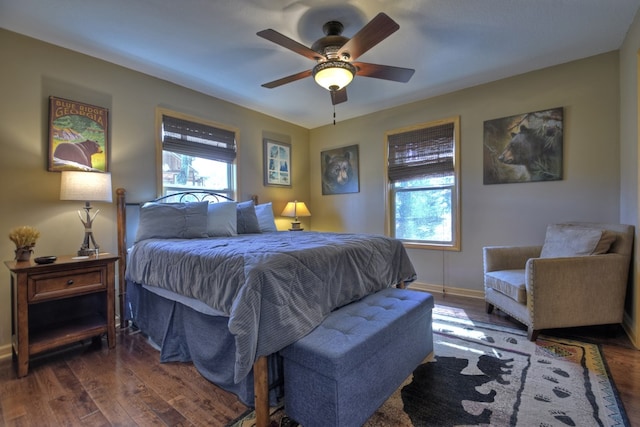 bedroom featuring multiple windows, a ceiling fan, and wood finished floors