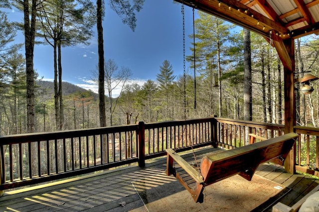 wooden deck with a forest view