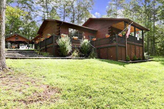 view of side of property featuring a wooden deck and a yard