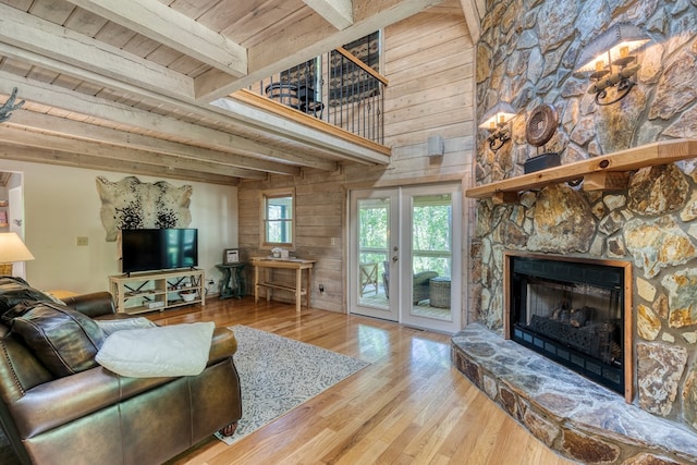 50 Rustic Rdg, Blue Ridge, GA 30513 - living area with wood finished floors, wood walls, a stone fireplace, wood ceiling with exposed beams, and a towering ceiling