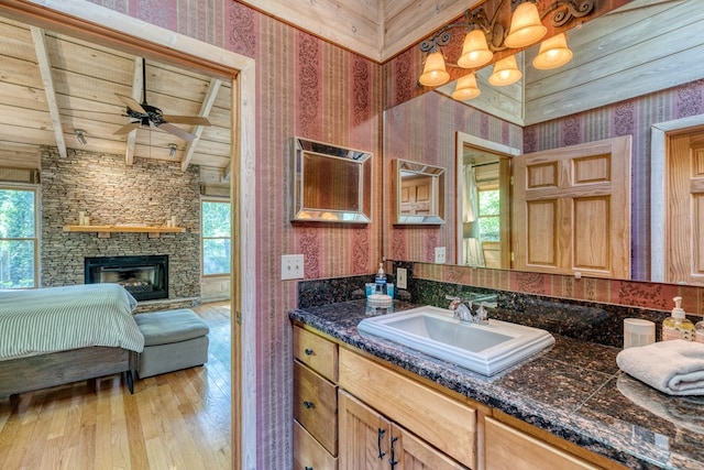 50 Rustic Rdg, Blue Ridge, GA 30513 - ensuite bathroom featuring wallpapered walls, plenty of natural light, hardwood / wood-style flooring, wooden ceiling with exposed beams, and vanity