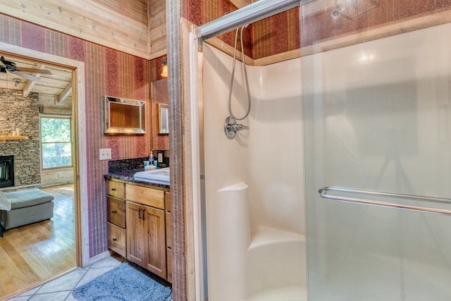 50 Rustic Rdg, Blue Ridge, GA 30513 - full bath with a stall shower, vanity, wallpapered walls, beam ceiling, and tile patterned flooring