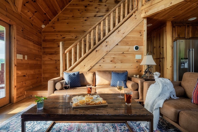 living room with hardwood / wood-style flooring, vaulted ceiling, wooden ceiling, and wood walls