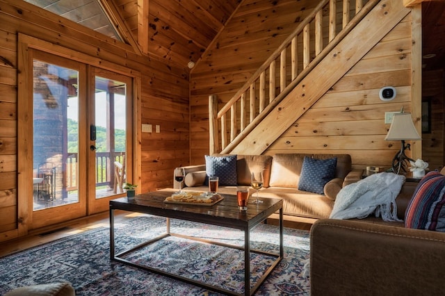 living room featuring hardwood / wood-style flooring, wood ceiling, lofted ceiling, and wood walls