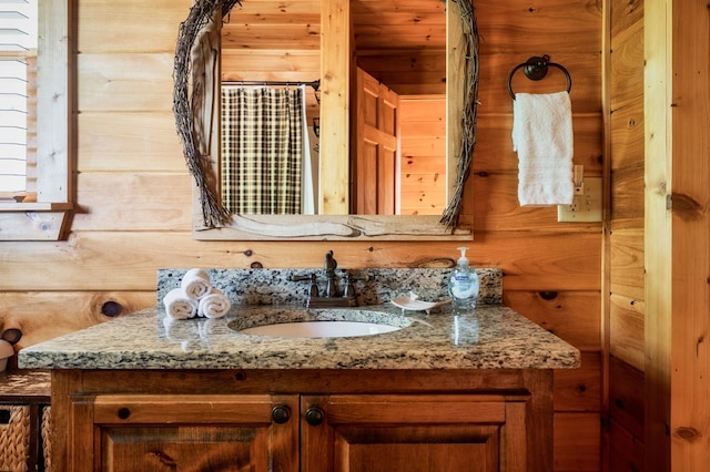 bathroom with vanity and wood walls