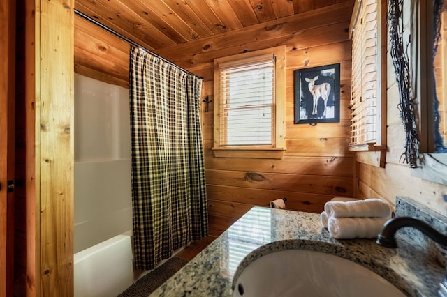 bathroom with shower / tub combo, vanity, wood ceiling, and wood walls